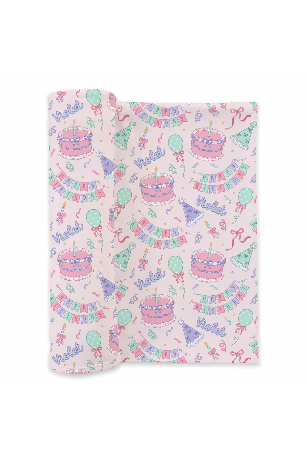 A Caden Lane folded baby swaddle with a light pink background and a colorful birthday print featuring cakes, balloons, banners, and happy birthday.