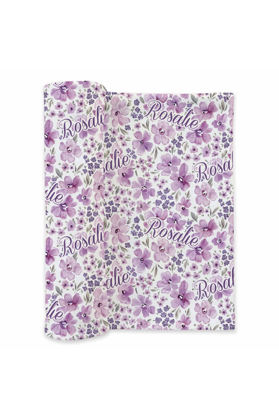 Flat lay of a partially unrolled Caden Lane white knit swaddle in a Lilac Dreams print featuring purple watercolor flowers and grey leaves, reading "Rosalie."