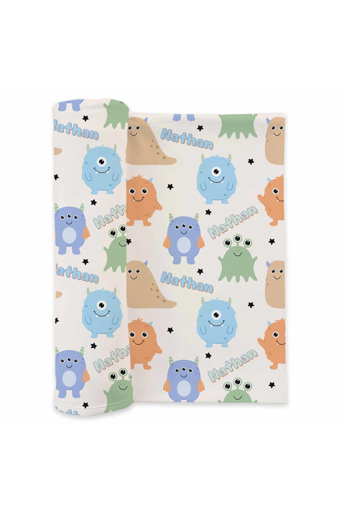 Product shot of Caden Lane personalized "Nathan" swaddle blanket rolled out, showing Little Monsters print with blue, purple, orange, tan, and green cartoon monsters and stars on a cream background