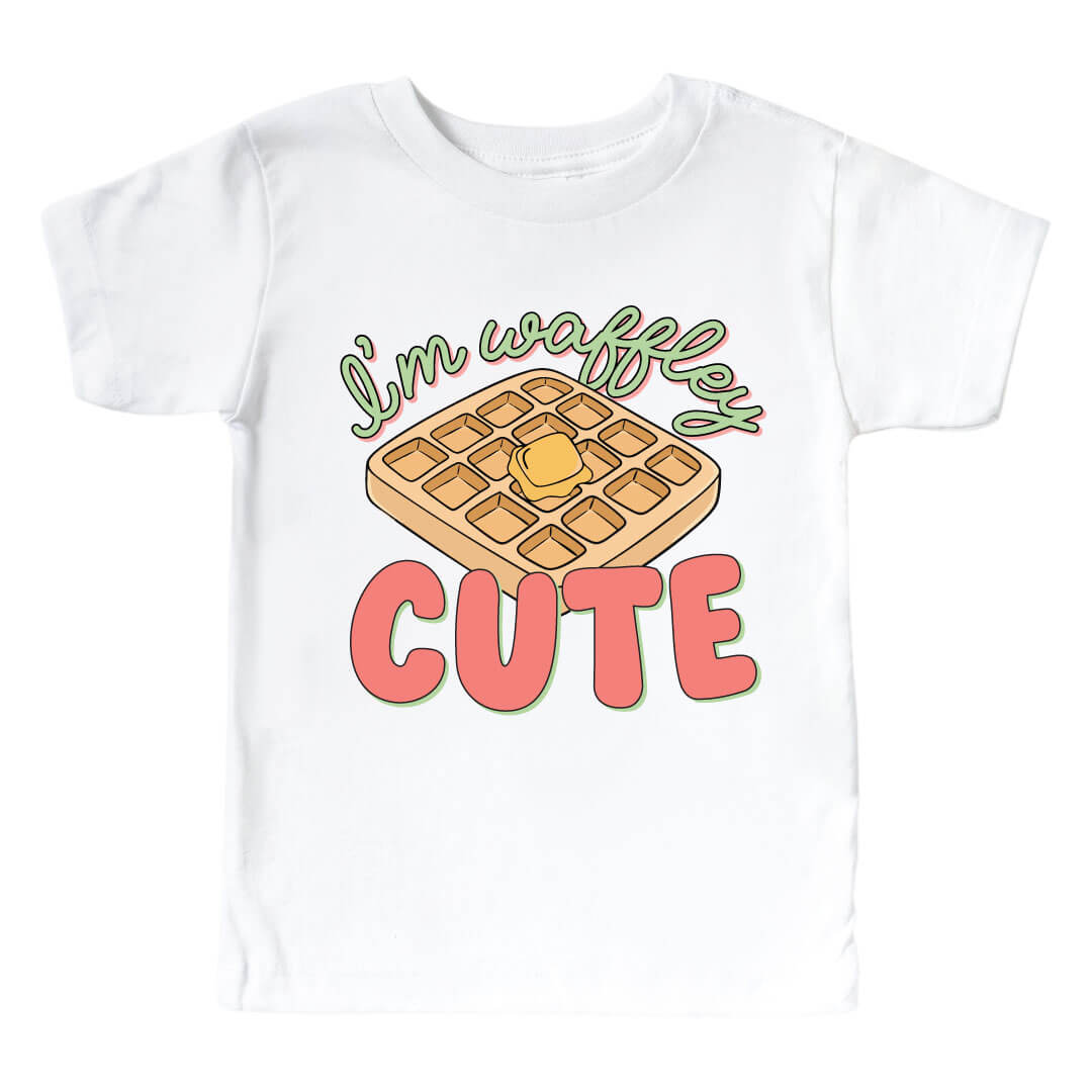 White "I'm Waffley Cute" Pink Graphic Kids Tee. Green and pink color font with waffle with butter in the center.  