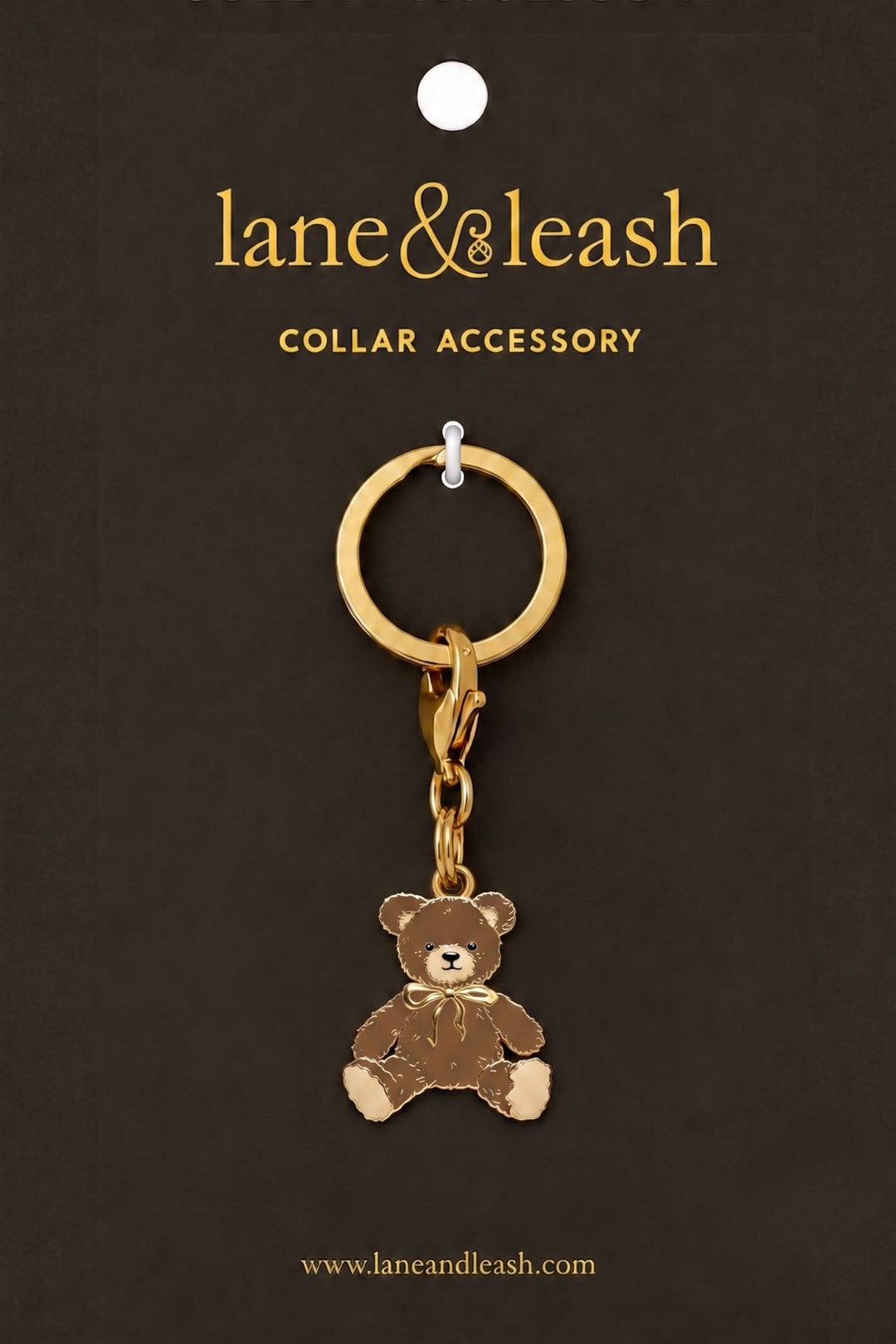 A Lane & Leash collar accessory with a small teddy bear charm, displayed on a dark brown backing card with the brand name 'lane&leash' printed at the top.
