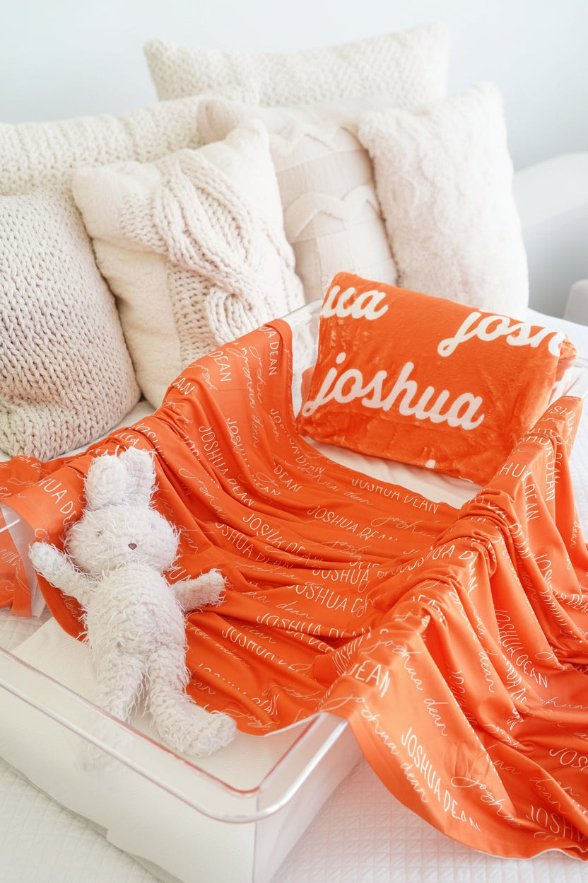 orange swaddle across bassinet