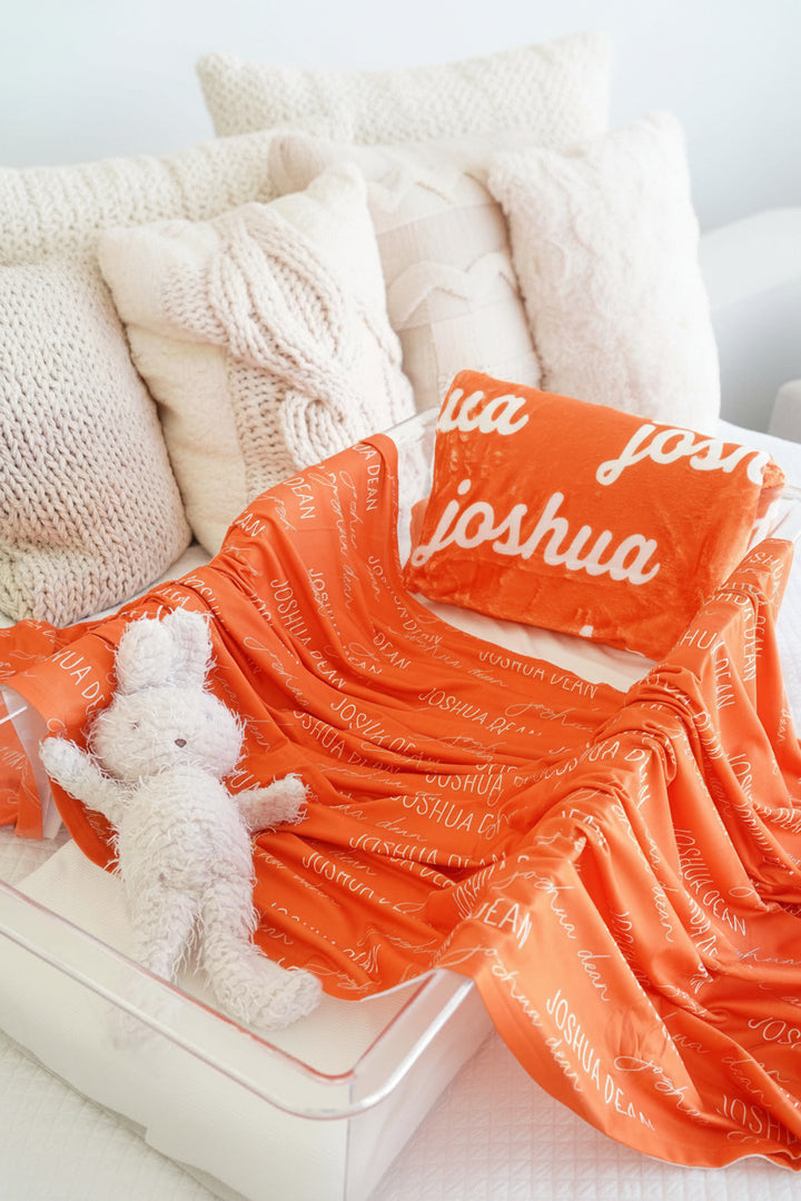 orange swaddle across bassinet