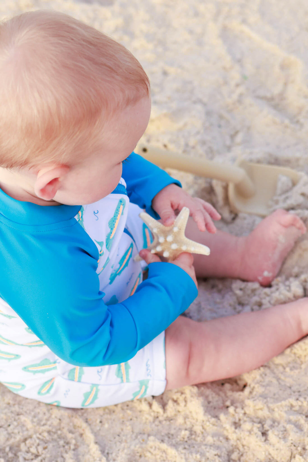 top view of tiny trout swim romper shortie 