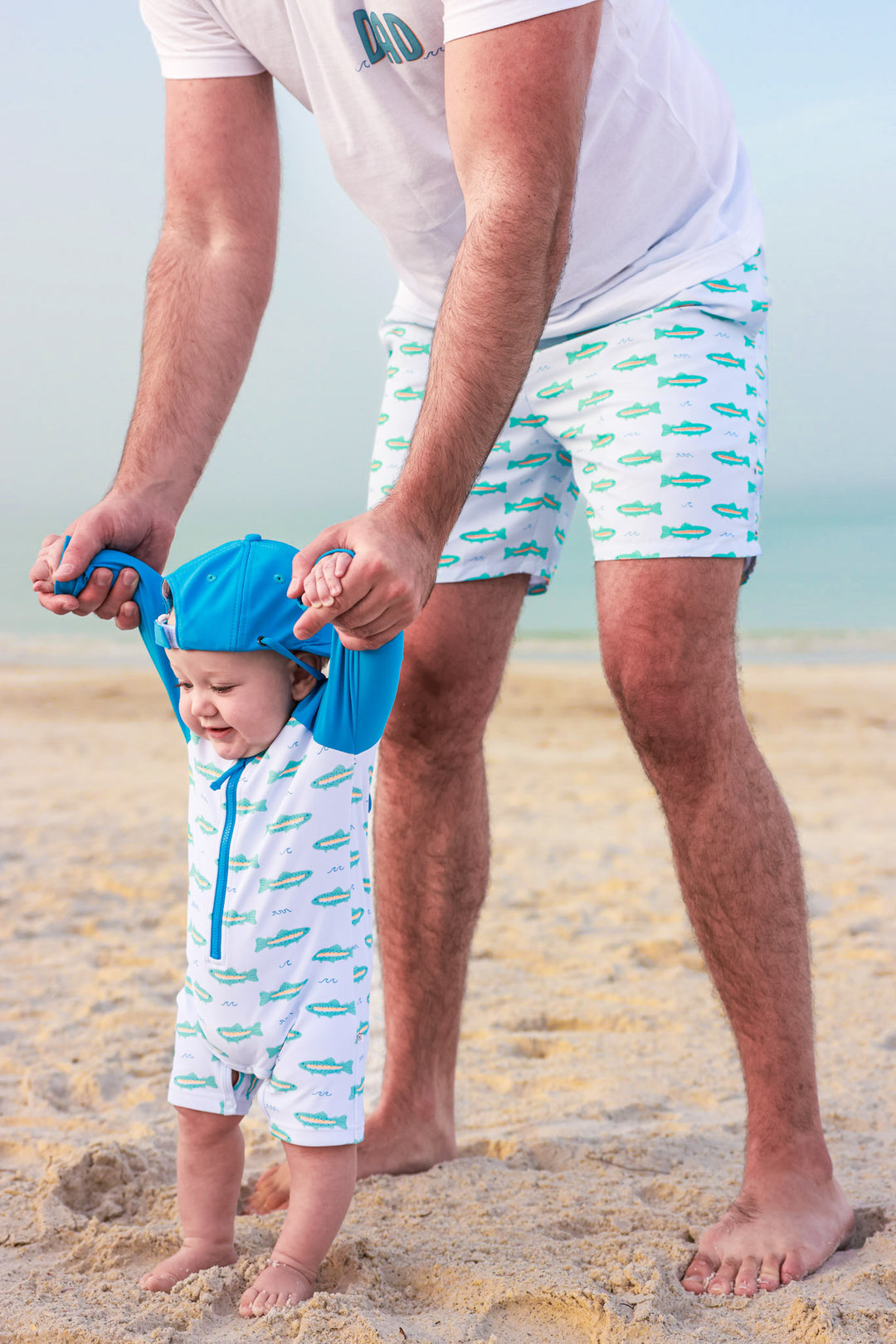 tiny trout swim romper, matching surf hat and trunks for dad 