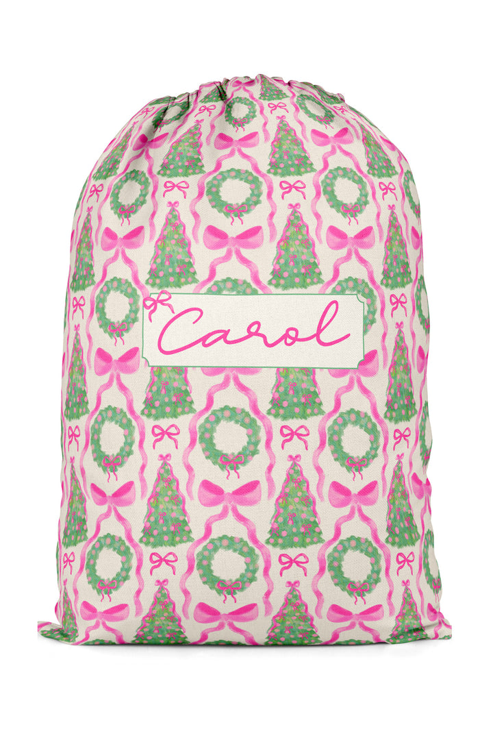 Caden Lane personalzied Under the Tree Santa Sack. The print features green wreath with large pink bows. 