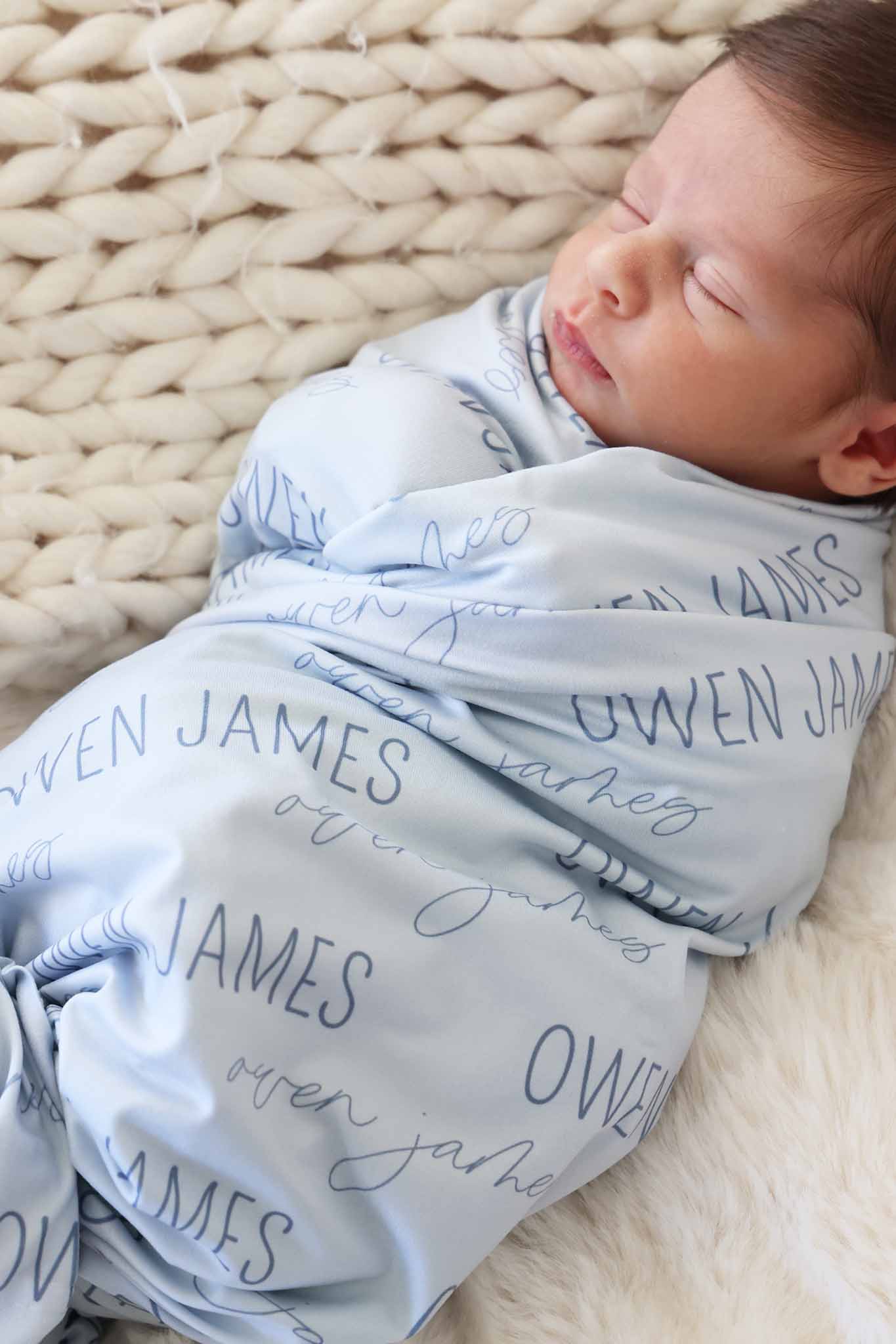 closeup of block and script font personalized blue swaddle blanket for boys 