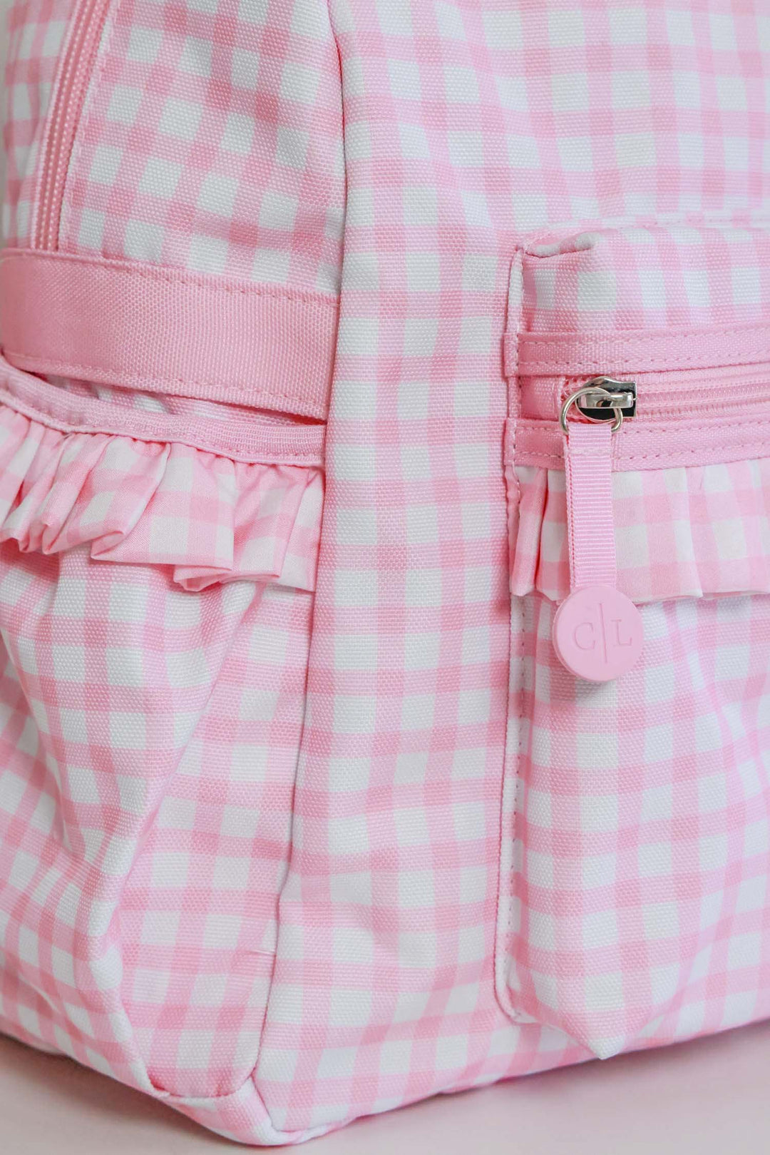 closeup of zipper and pocket on pink gingham backpack 
