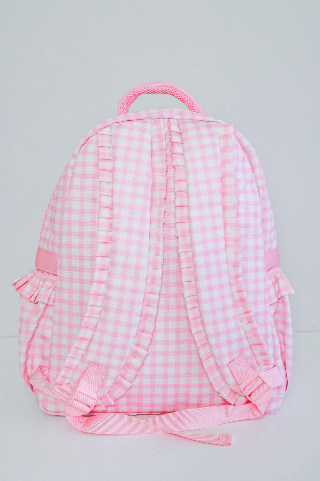 view of straps on pink gingham backpack 
