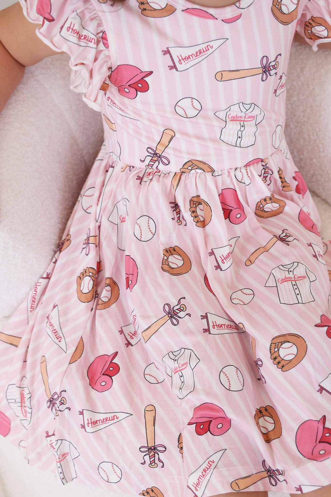 girl sitting on chair in ballpark babes girly baseball dress 