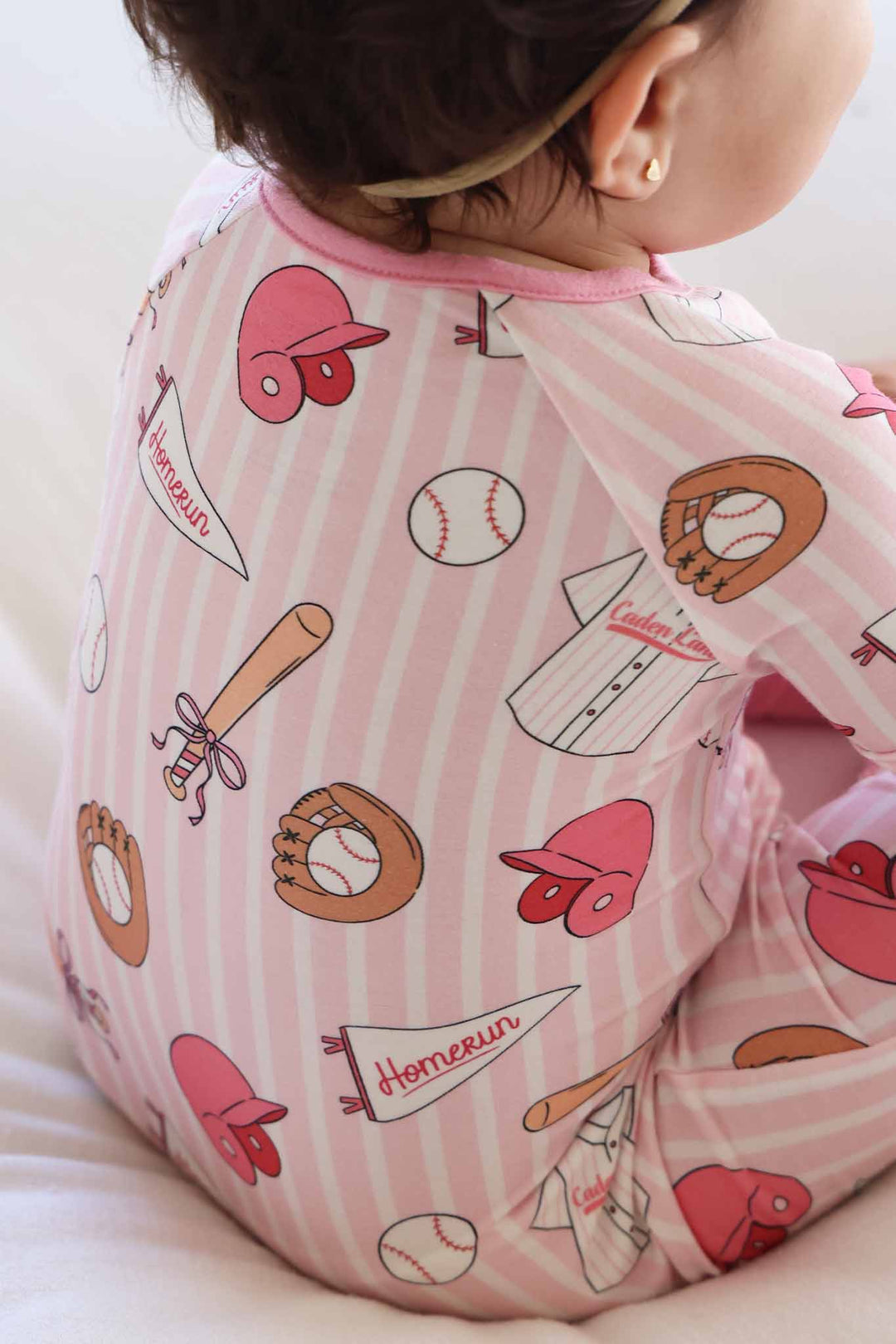 closeup of ballpark babes print with helmets, gloves, bats, baseballs and flag banners 