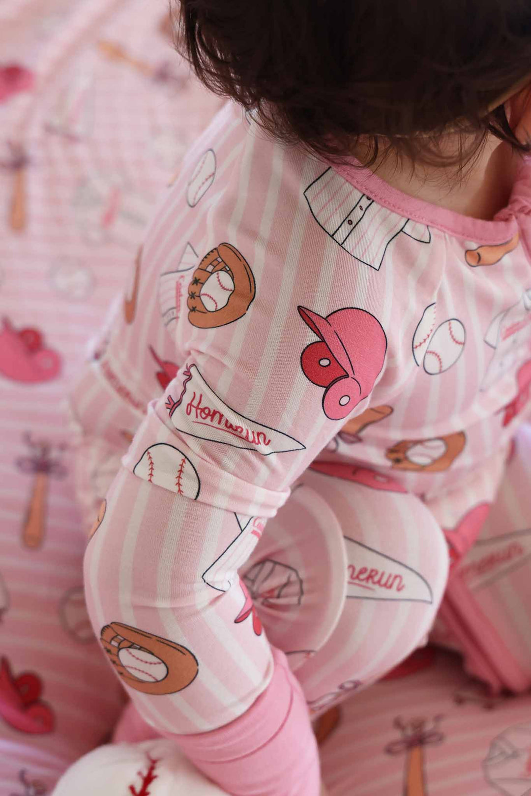 closeup of pink and white striped girly baseball convertible zip romper for baby and toddler girls 