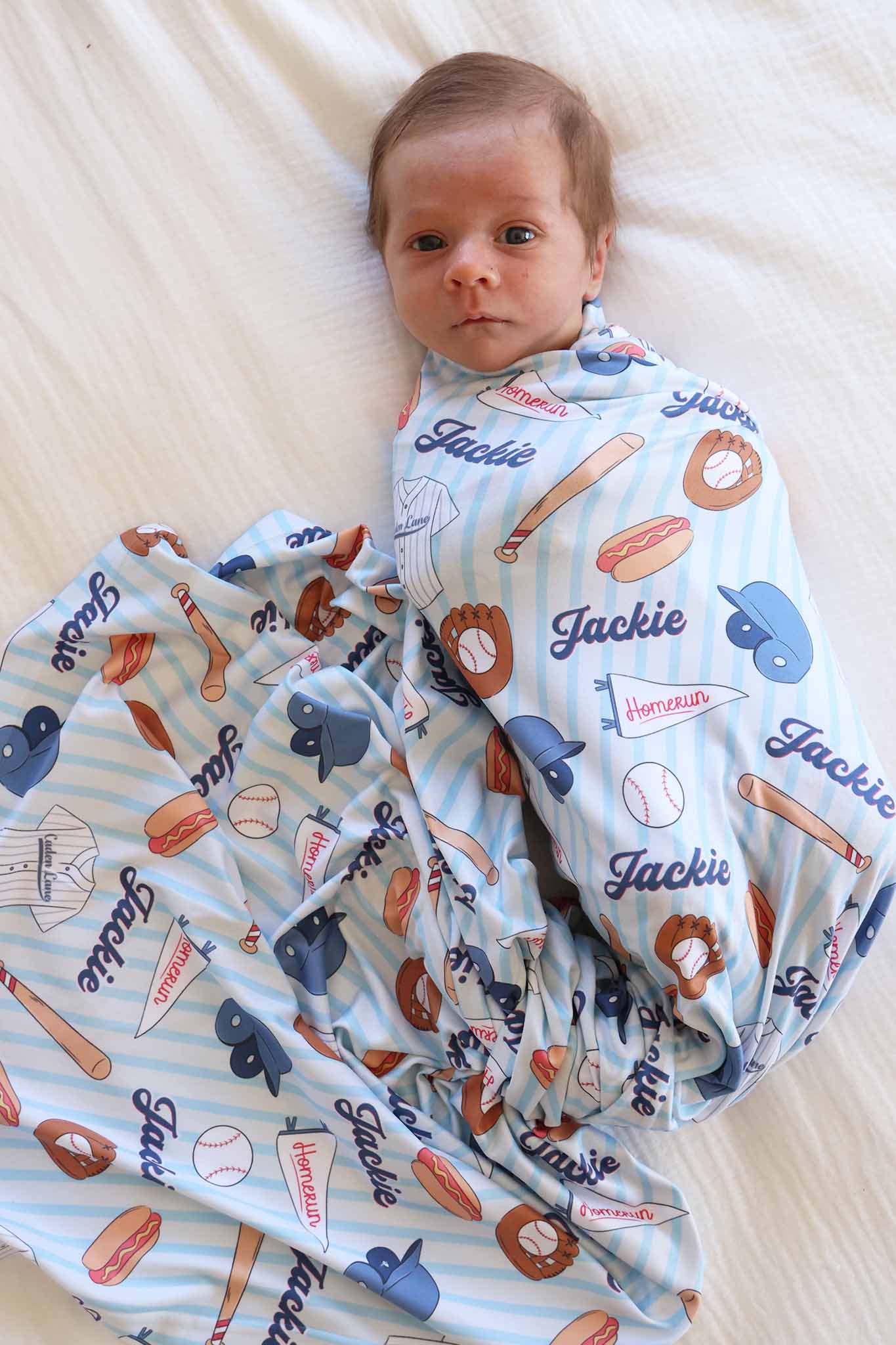 baby boy wrapped in ballpark bros personalized swaddle blanket 