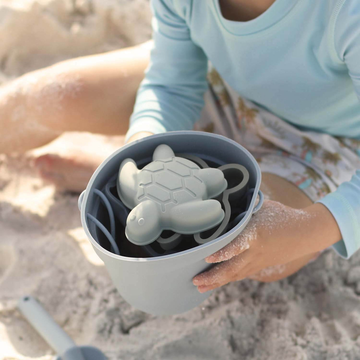 blue beach bucket with sand molds 