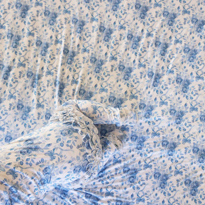 baby wearing betsy's blooms ruffle zipper footie crawling on a matching double sided bamboo blanket 