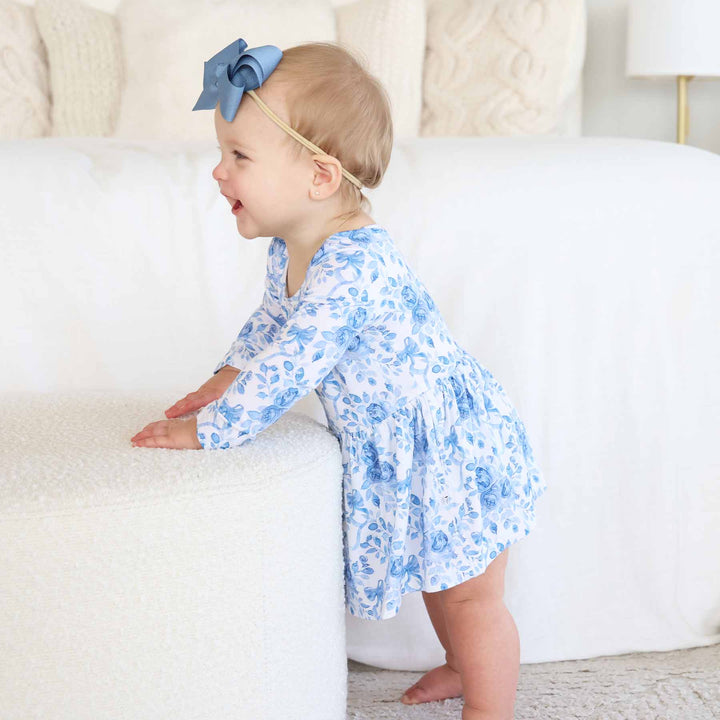 baby girl skirt bodysuit with blue and white floral and bow print 
