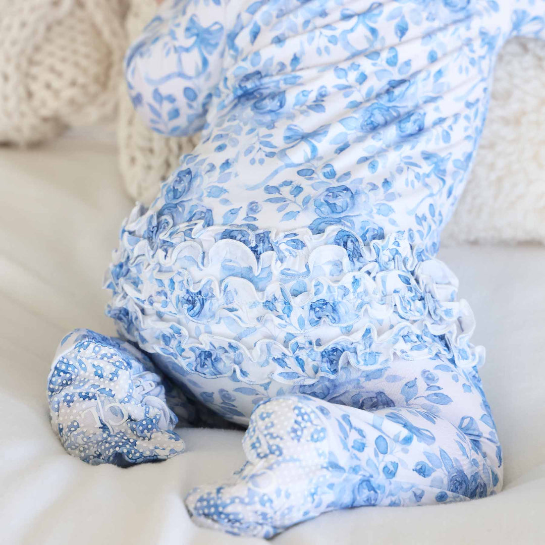 baby sitting on knees in bamboo waffle ruffle zipper footie betsy's blooms 