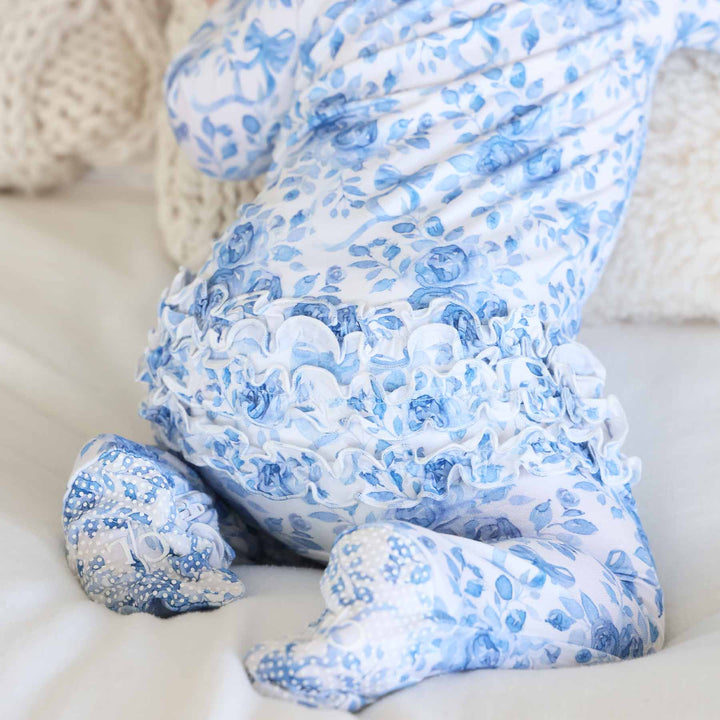 baby sitting on knees in bamboo waffle ruffle zipper footie betsy's blooms 