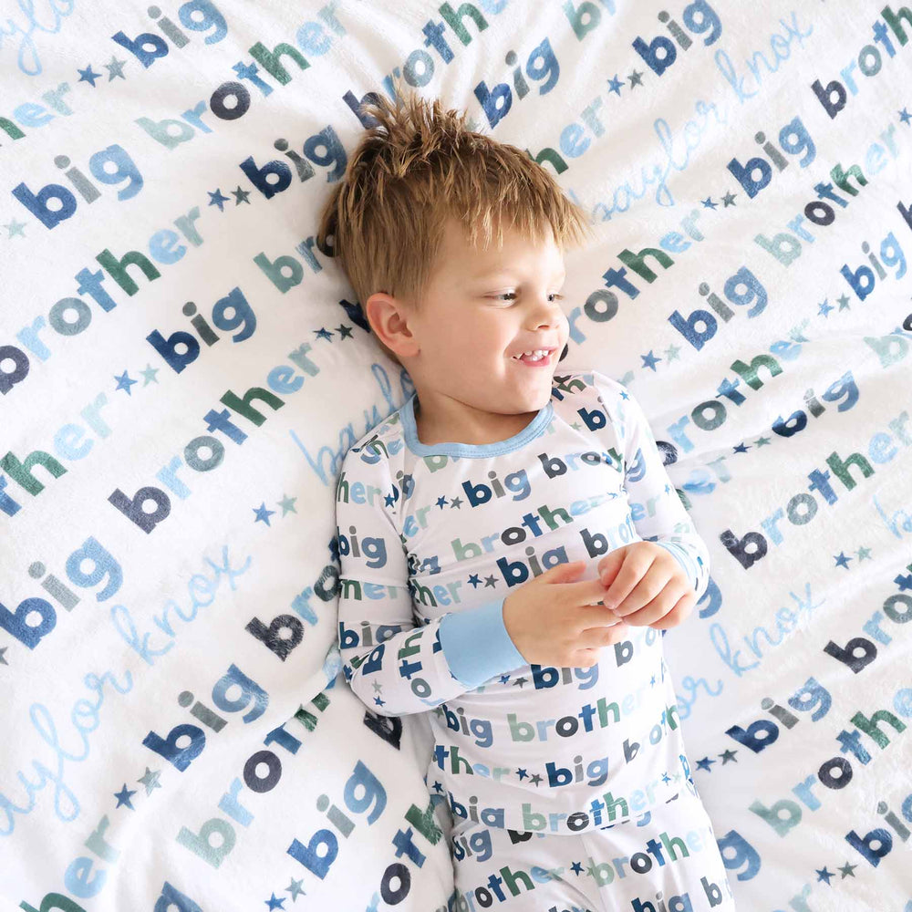 boy with matching big brother personalized kids blanket and pajamas