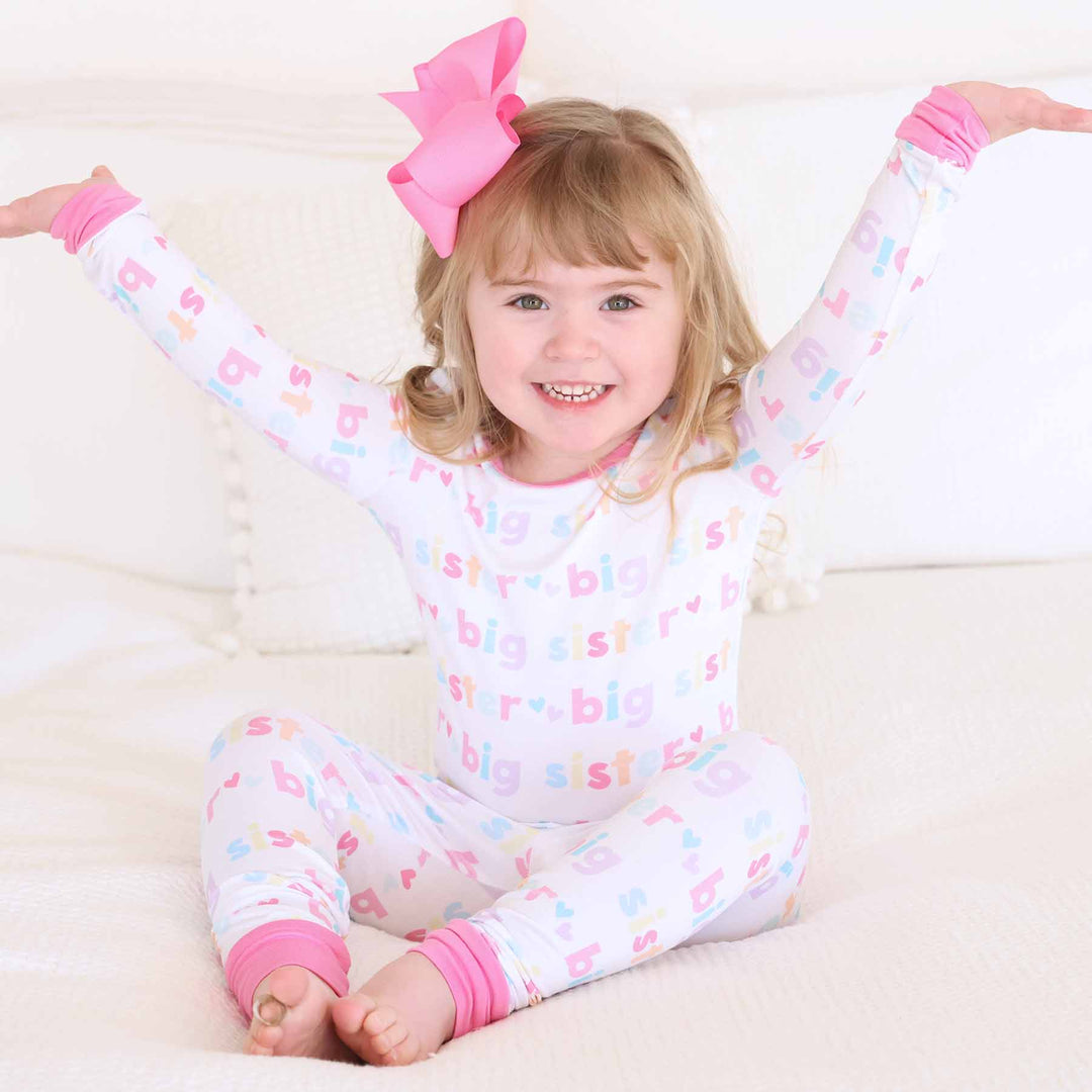 girl wearing big sister two-piece pajama set