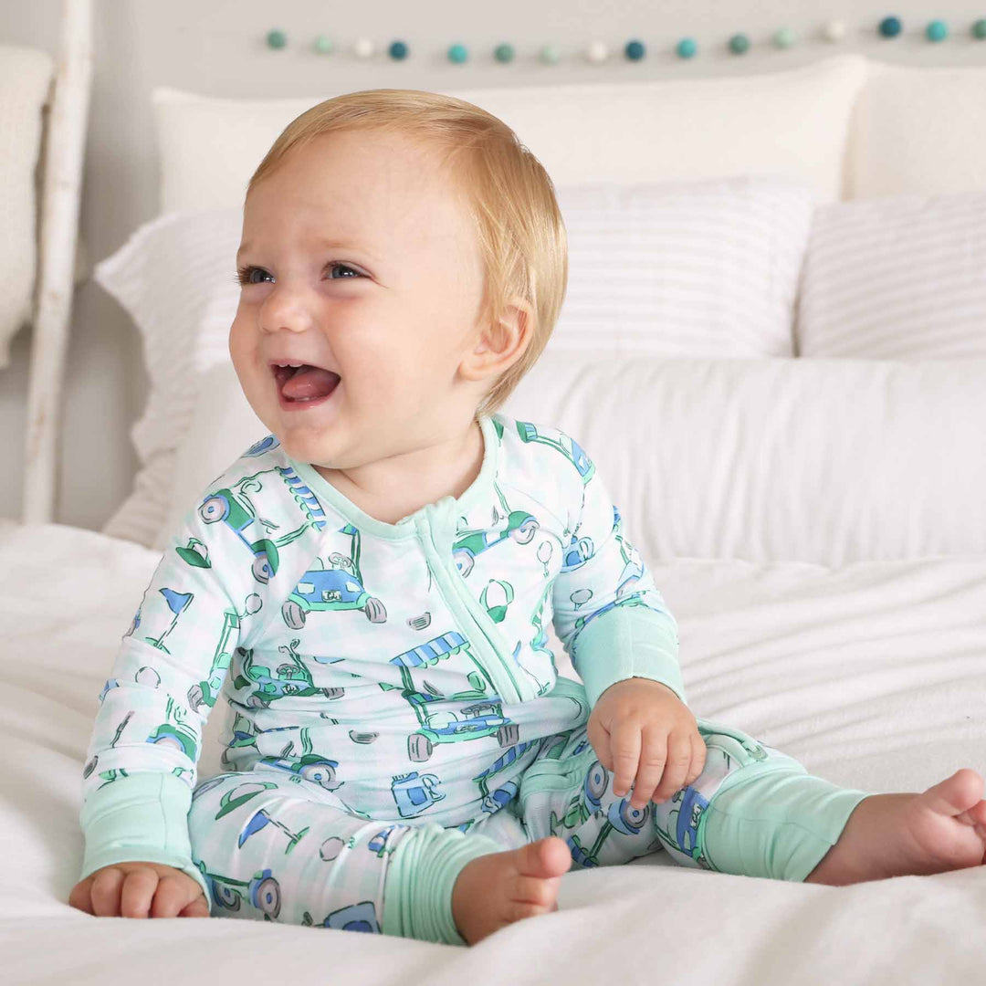 romper pajama with golf carts, clubs, bags and balls 