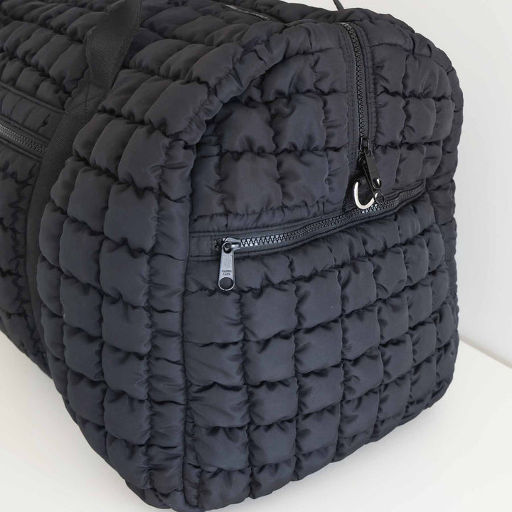black quilted square duffel bag for women with long shoulder strap and d-rings 