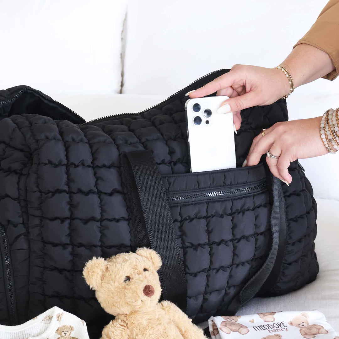 black quilted overnight bag with side and front pockets 