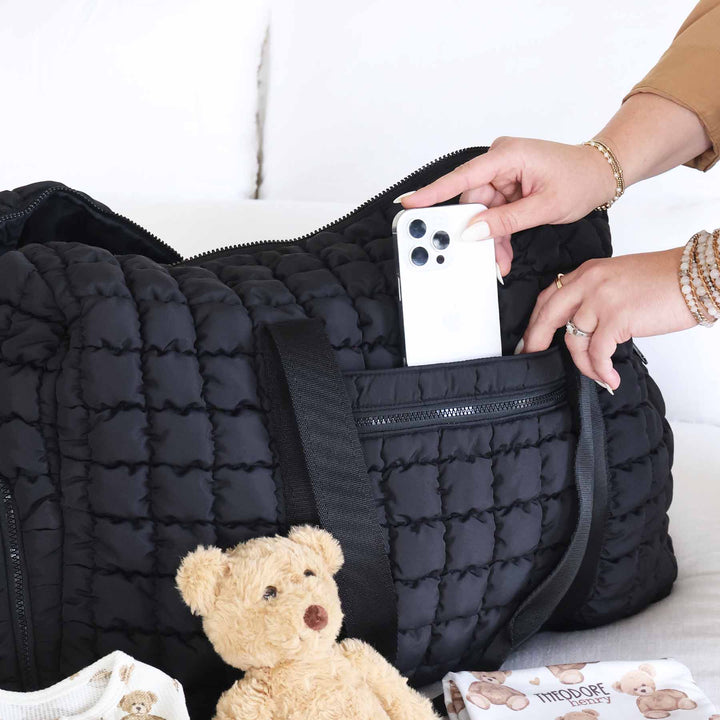 black quilted overnight bag with side and front pockets 