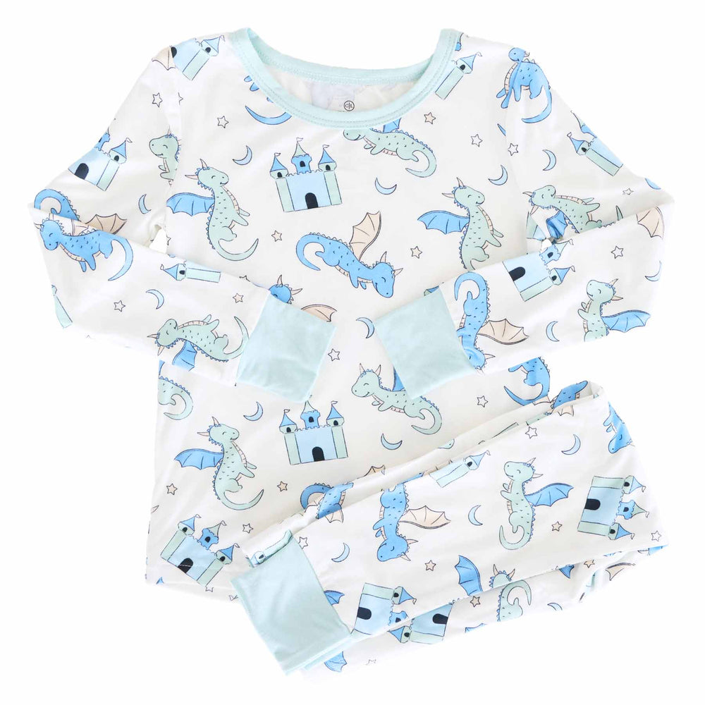 Toddler cream pajamas with blue dragons and castles