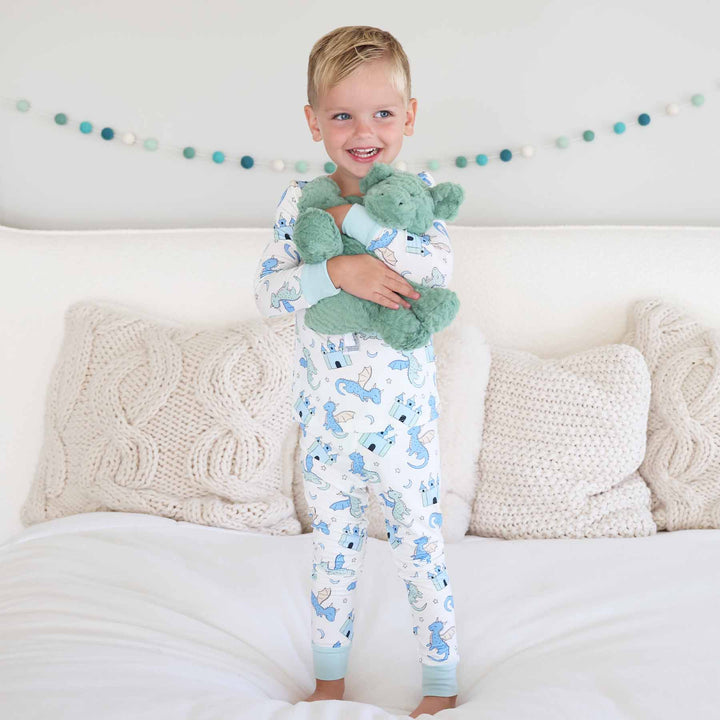 Boy dressed in fantasy castle and dragon pajamas for kids
