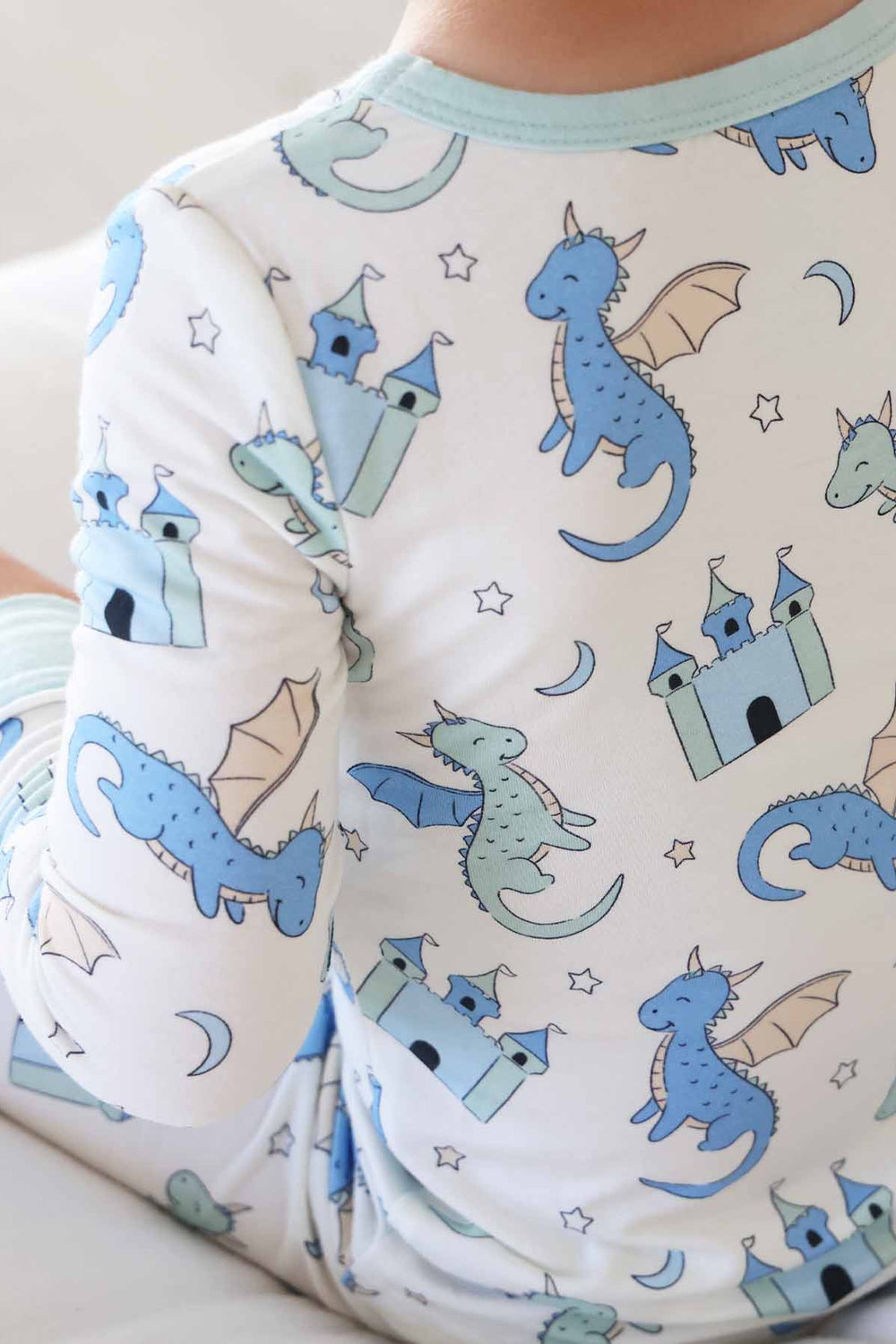 Boy dressed in fantasy castle and dragon pajamas for kids