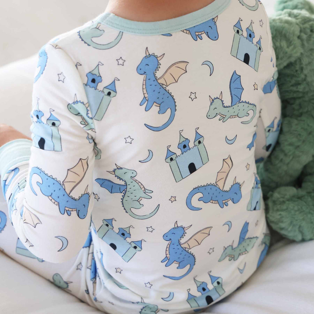 Boy dressed in fantasy castle and dragon pajamas for kids