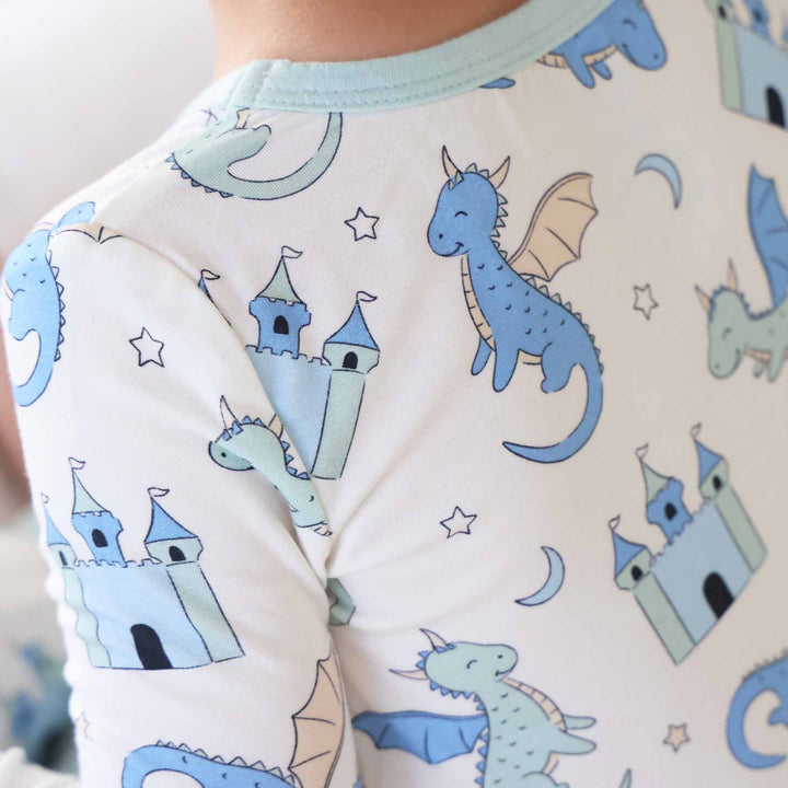 Toddler wearing soft pajama set decorated with mythical creatures