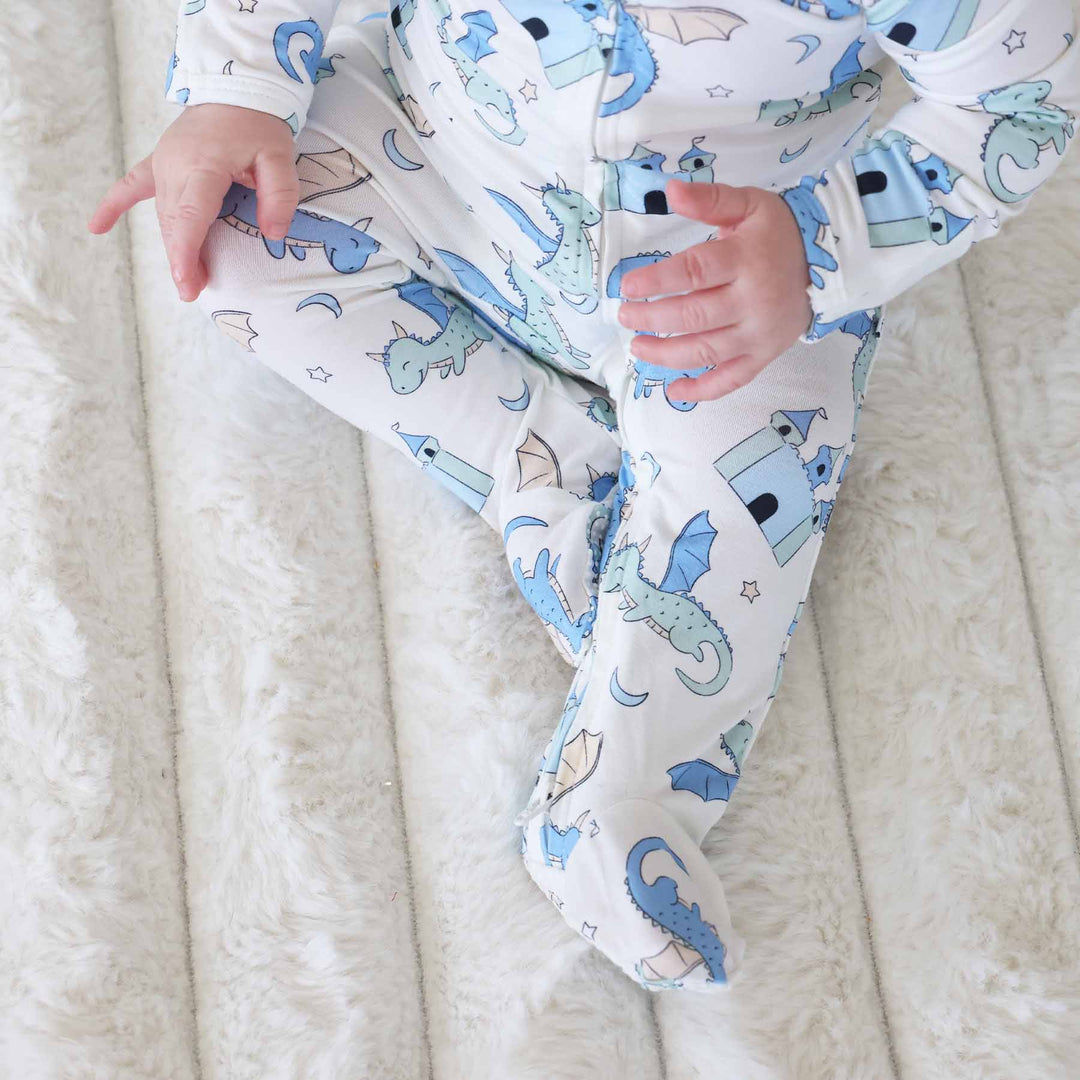 Baby pajamas decorated with blue castles and dragons
