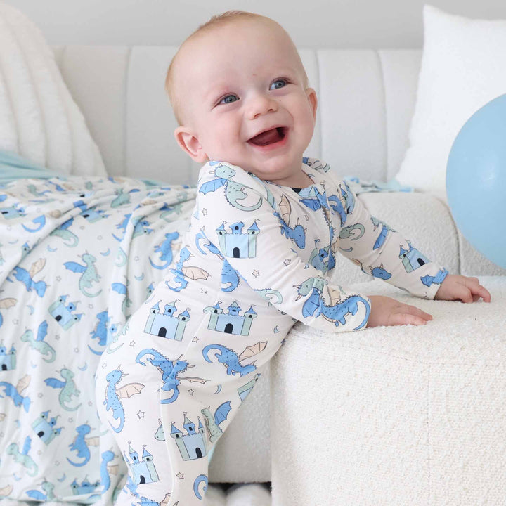 Baby boy wearing fantasy print zipper pajamas with dragons and castles
