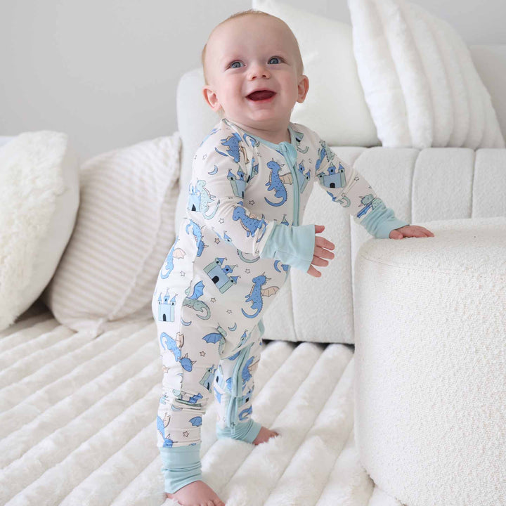 Infant dressed in whimsical dragon print convertible zip sleeper