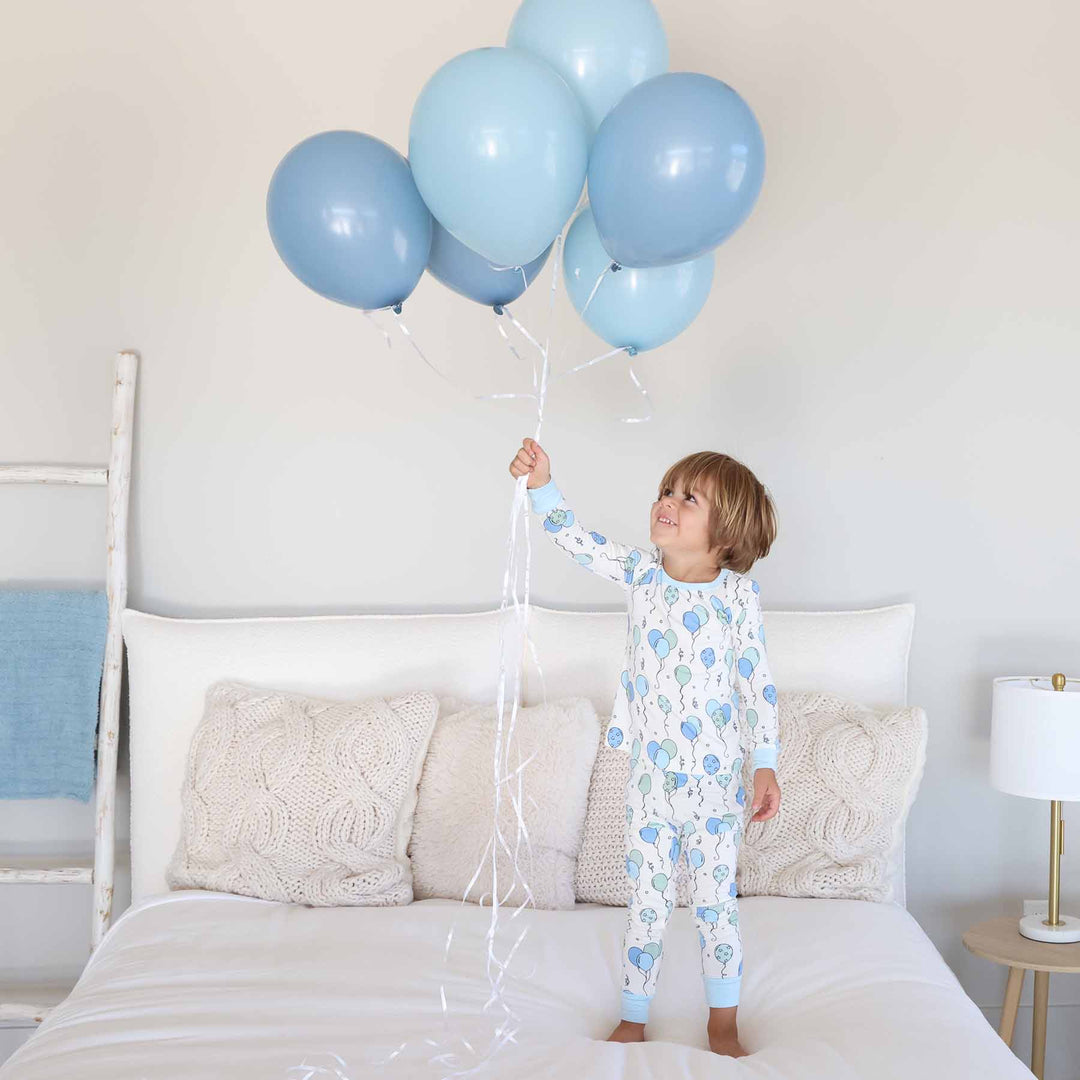 boy in birthday-themed two piece pajama set 