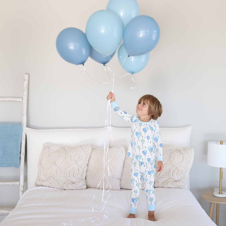 boy in birthday-themed two piece pajama set 