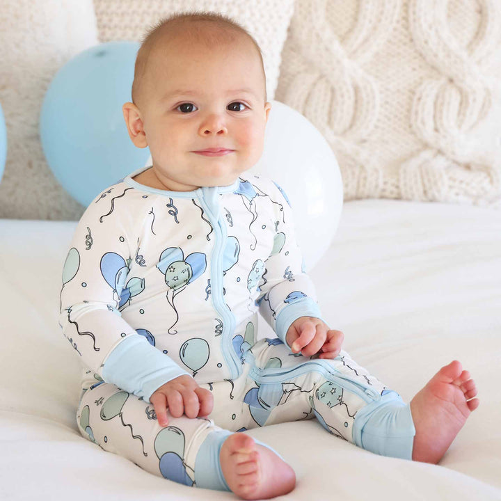 boy wearing blue and green balloon bamboo long sleeve convertible zip romper 