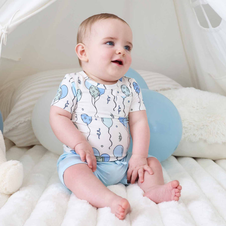 baby boy sitting wearing party time blue shirt and short set