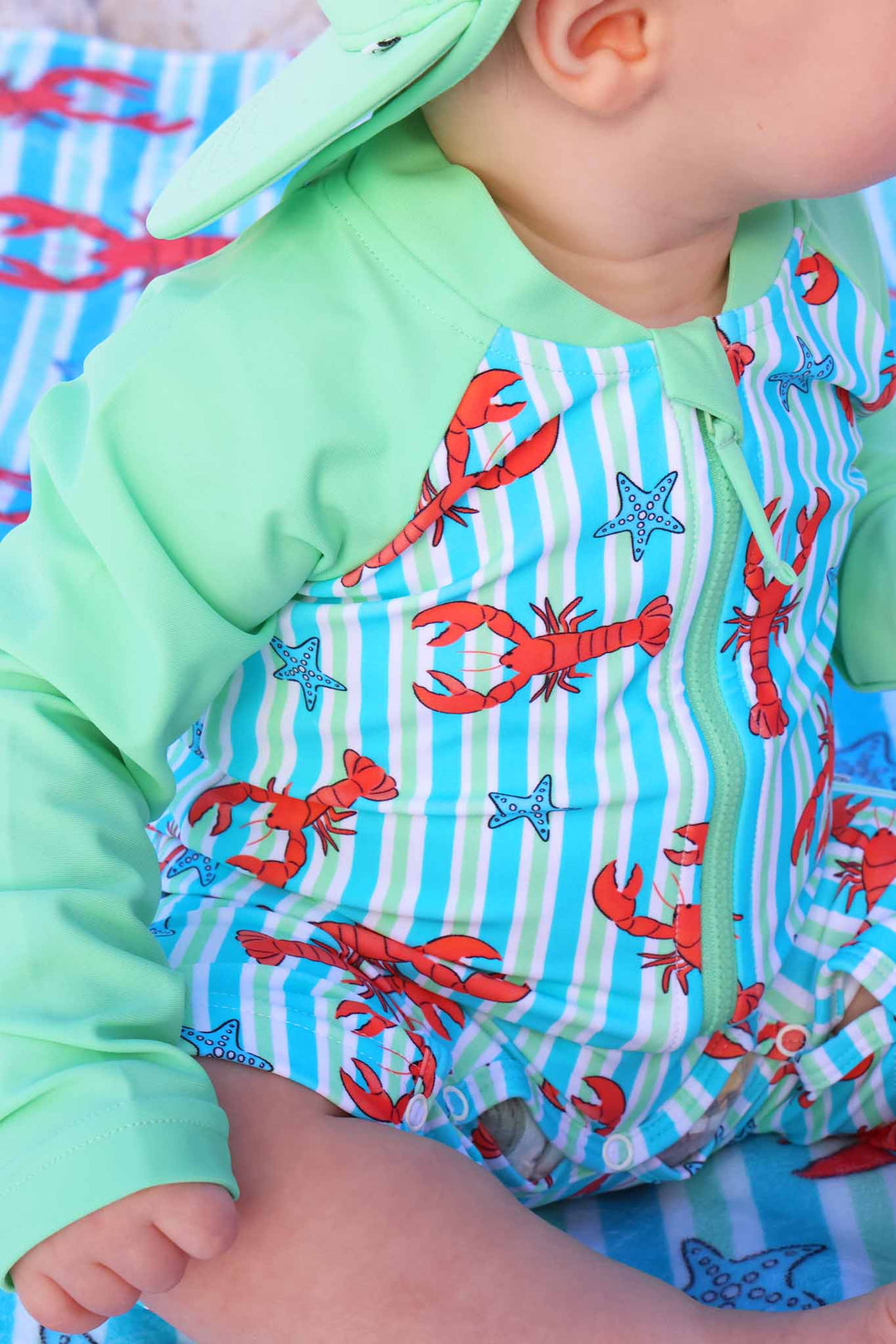 closeup of blue pinch me rash guard shortie romper 