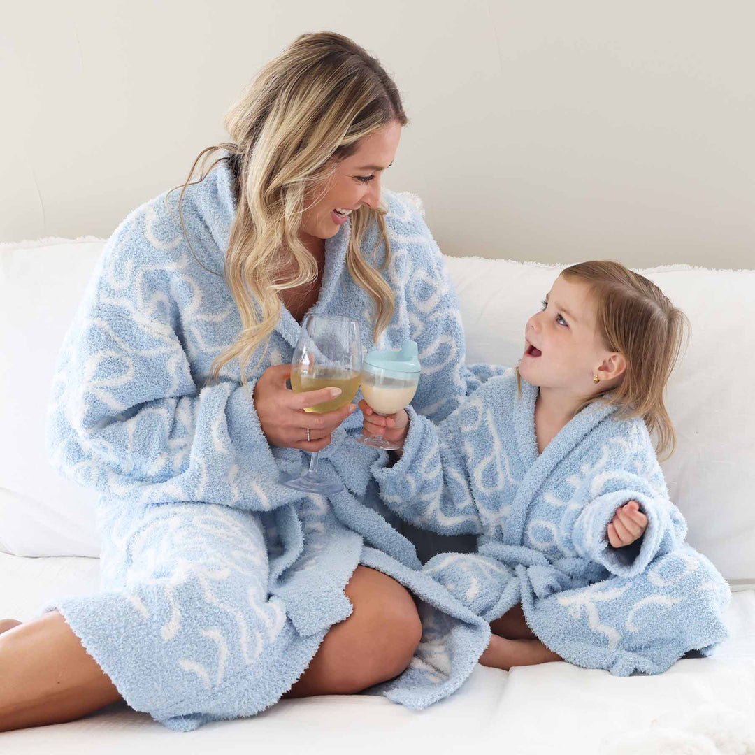 mom and daughter wearing matching light blue robes with white bows made from cuddlelane microfiber fabric 