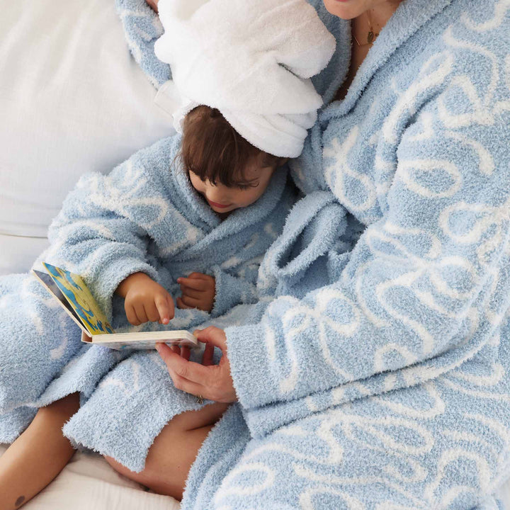 closeup or mommy and me matching robes in light blue and white bow print
