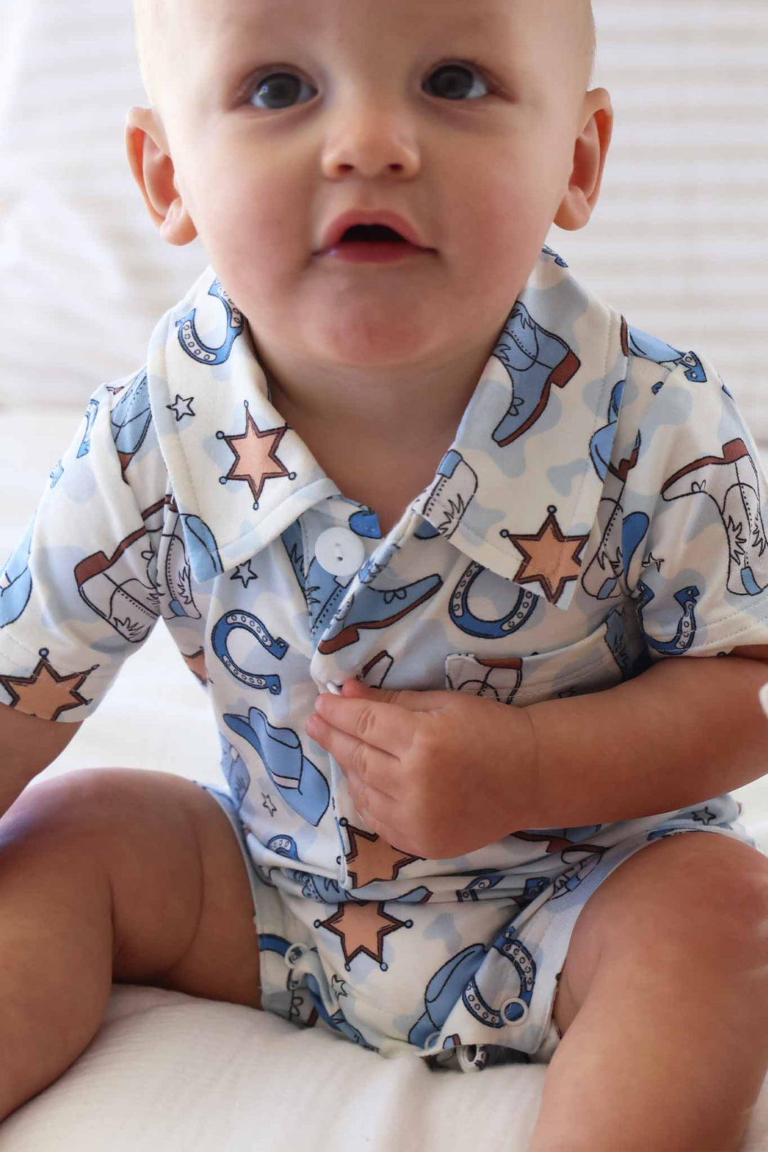 short sleeve front pocket collared button romper in blue rodeo dreams print 