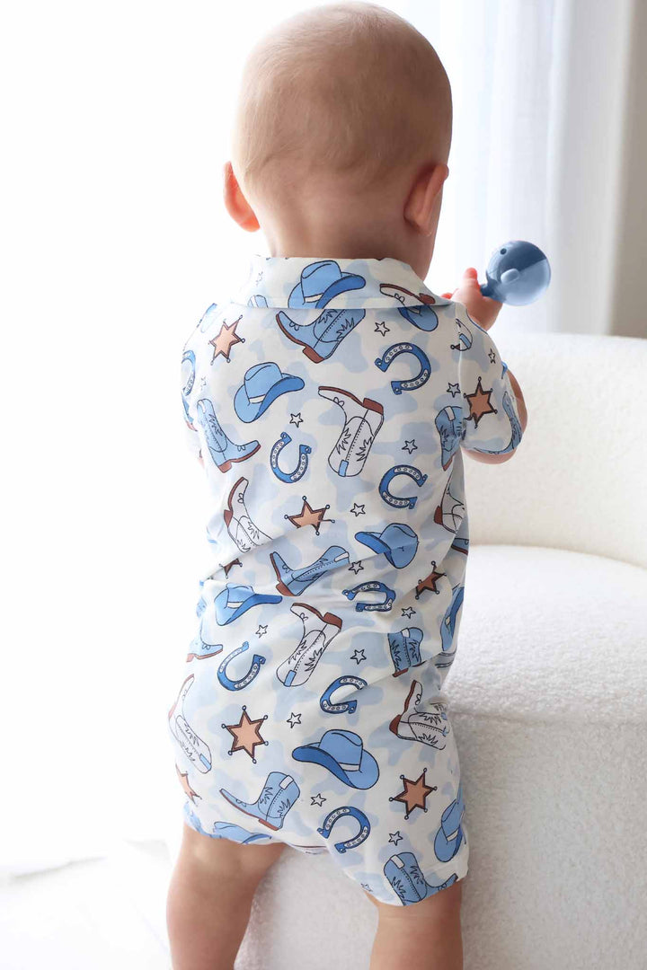 blue collared button up shorts romper with cowboy hats, boots, horseshoes and sheriff stars 