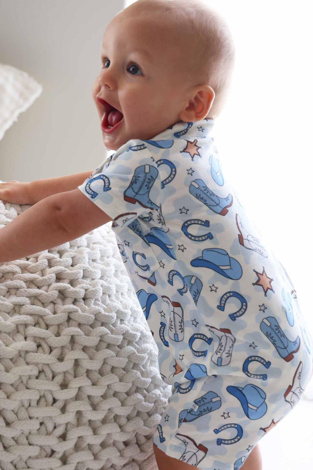 side view of blue rodeo dreams button collar romper for boys 