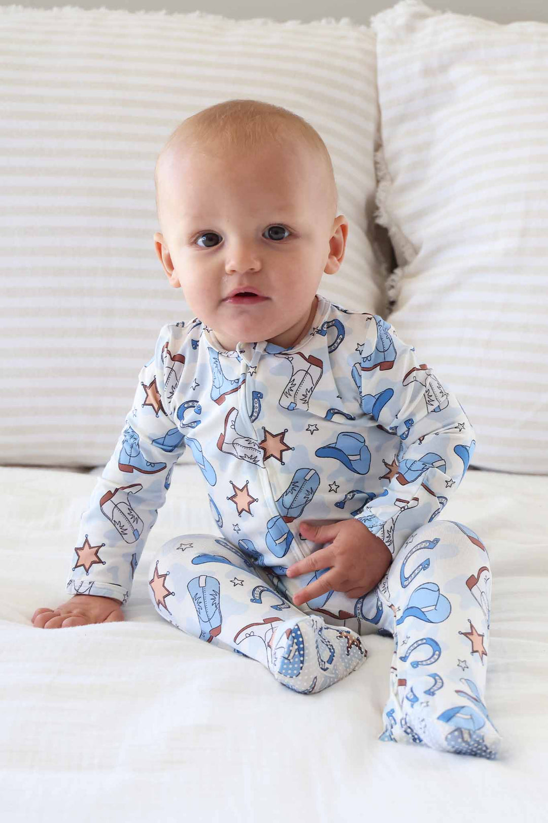 baby boy long sleeve footie pajama with grips on feet in blue rodeo print 