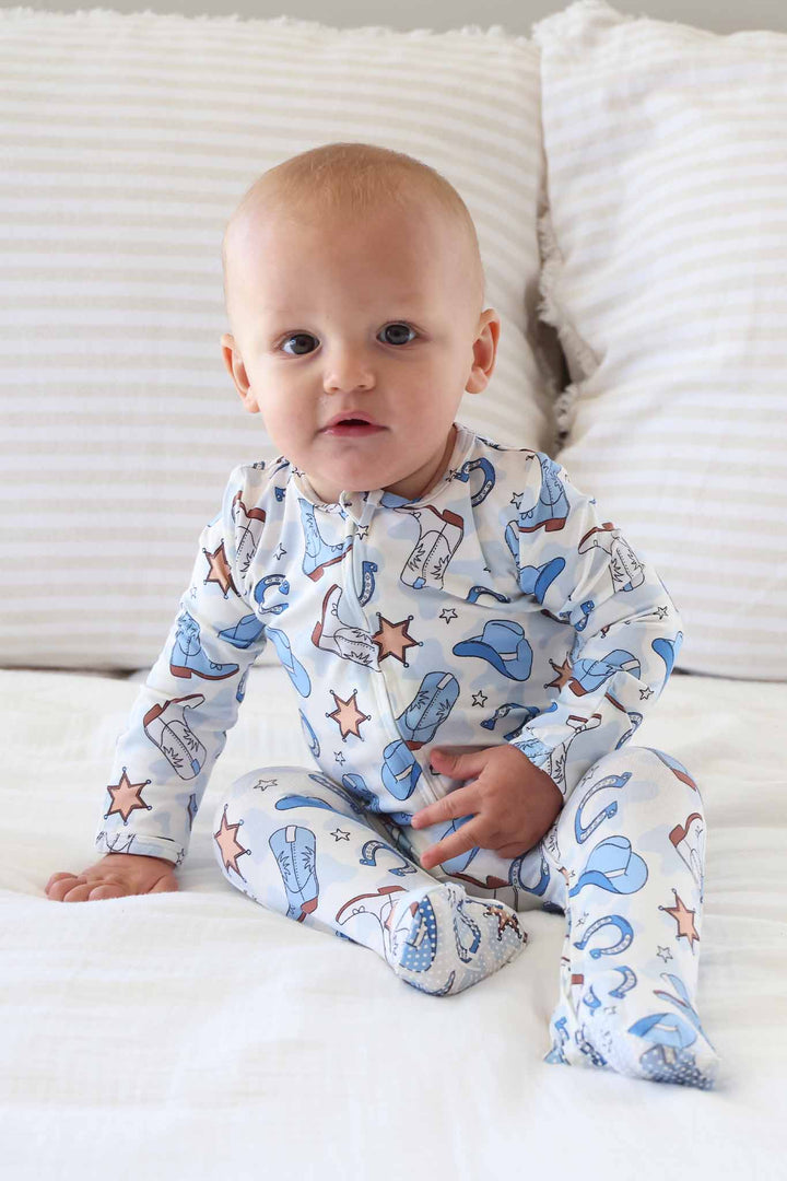baby boy long sleeve footie pajama with grips on feet in blue rodeo print 