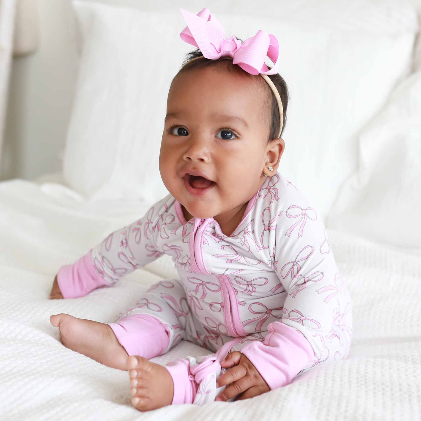 pink and white pajama romper for baby girls with bows 