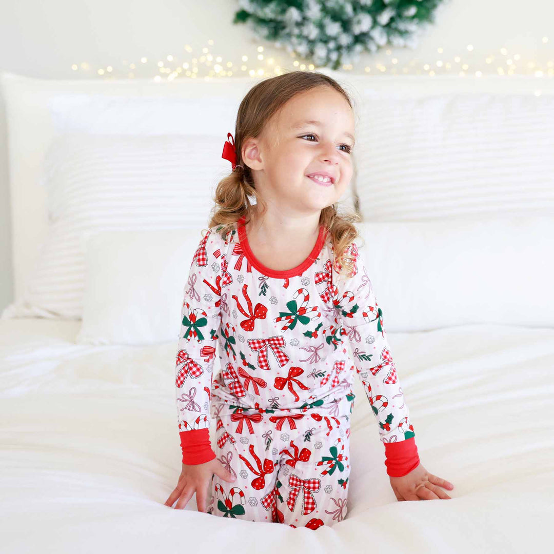 Little girl wearing the Bow What Fun Two Piece Pajama Set